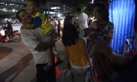 People react near a hospital, where the children’s football team members are being treated.