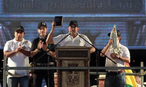 Luis Fernando Camacho, an ultra-conservative Catholic activist and probable presidential candidate, delivers a speech in Santa Cruz, Bolivia, brandishing a Bible and flanked by a statue of the Virgin Mary.