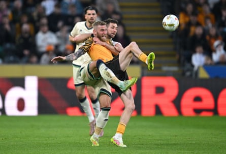 Hull’s Oli McBurnie and Millwall defender Ryan Leonard compete for the ball