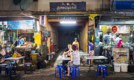 People eat at street food stalls on Sukhumvit Soi 38 in Bangkok.
