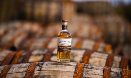 A bottle of Kingsbarn whisky on display on top of bourbon barrels at the distillery and visitor centre in St Andrews, Scotland.