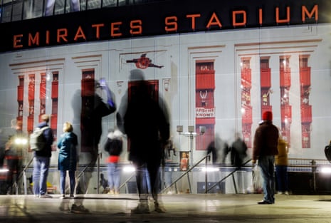 Fans arrive at the ground and take pictures of the old facade of the Highbury stadium before the UEFA Champions League last sixteen 2nd leg match between Arsenal and Bayer Leverkusen.