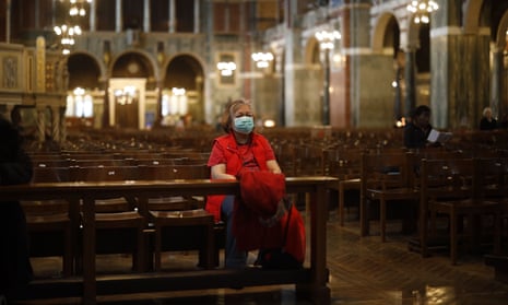 A worshipper sits in Westminster Cathedral in central London on 17 March 2020.