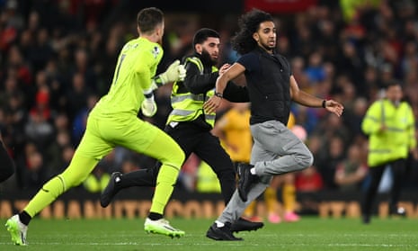 Wolves’ keeper Jose Sa and members of security chase a pitch invader during the Premier League match between Manchester United and Wolverhampton Wanderers.