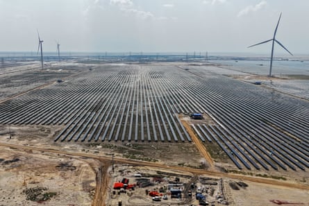 Aerial view of solar panels over a vast stretch of flat barren land