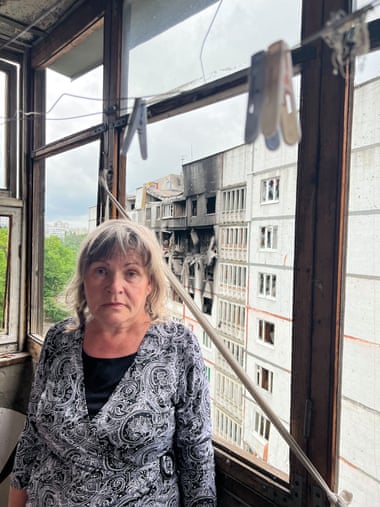 Tatyana Marchenko in her flat, with its shattered windows, in Saltivka.
