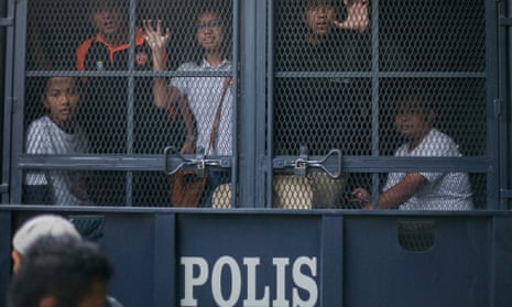 Malaysian protesters are held inside a police vehicle during protests against Malaysian Prime Minister Najib Razak in Kuala Lumpur in August.