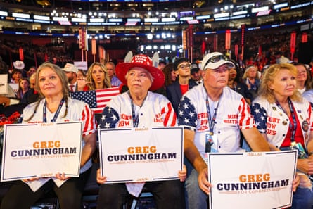 Convention attendees hold Greg Cunningham for Congress signs in a crowded arena