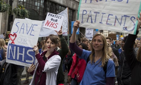Protesters hold banners at a demonstration in support of junior doctors in London.