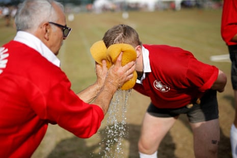A Swiss competitor in the senior mens 680kg category gets a double wet sponge to the face from a coach.