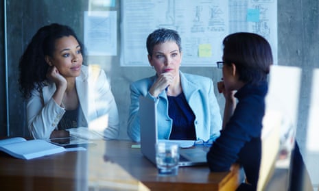 Three businesswomen discussing ideas in boardroom