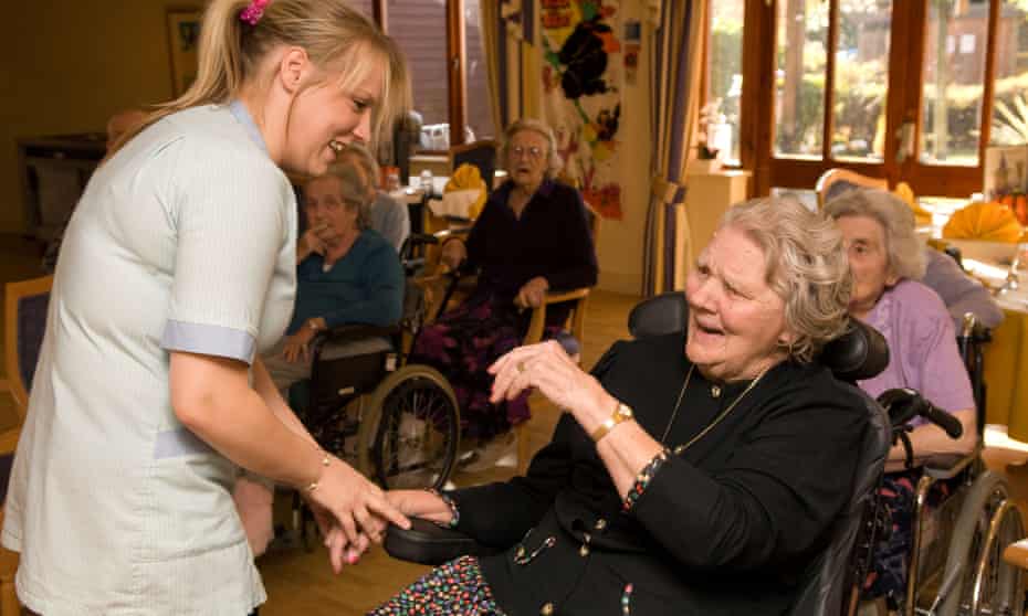 A care worker with a resident at a care home in Isleworth, Middlesex: ‘Caring will not qualify as sufficiently skilled to earn a visa, but all that brands this delicate work as “unskilled” is the appalling low pay.’