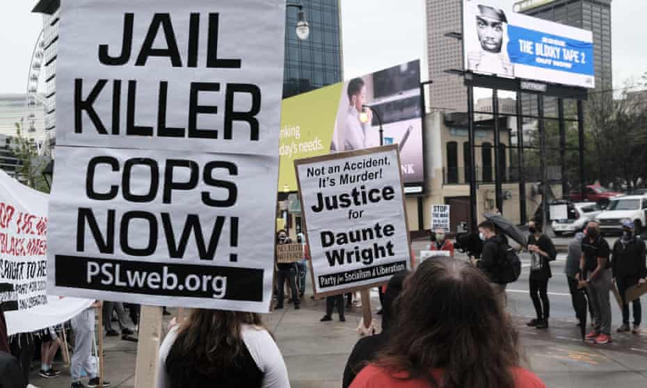 A group of demonstrators in Atlanta hold a rally for Daunte Wright, a 20-year-old black man who was shot and killed by a police officer in Brooklyn Center, Minnesota.