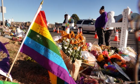 Mourners inspect a makeshift memorial for victims of Club Q mass shooting in Colorado Springs.