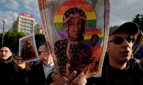 People hold pictures of the ‘Black Madonna of Czestochowa’ with a rainbow-coloured halo at a protest in Warsaw.