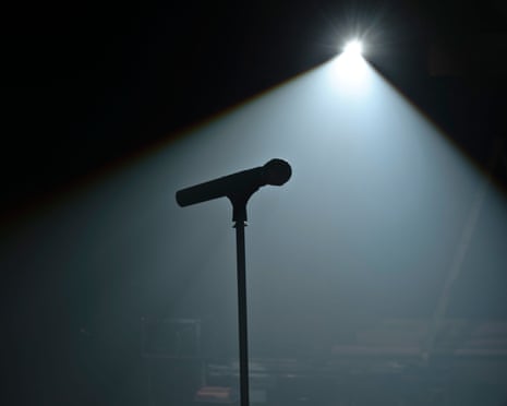A mic on a stand, spotlit