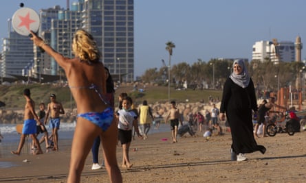 Palestinians and Israelis on the beach in Tel Aviv, Israel. Israel hopes it can revive its tourism industry by becoming a hub to replace Dubai or Doha.