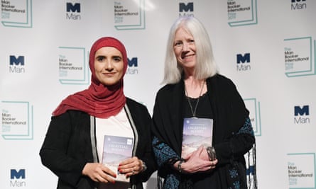 Omani author Jokha al-Harthi and translator Marilyn Booth holding Celestial Bodies.
