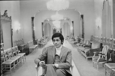 Valentino sits in a long room lined with empty chairs