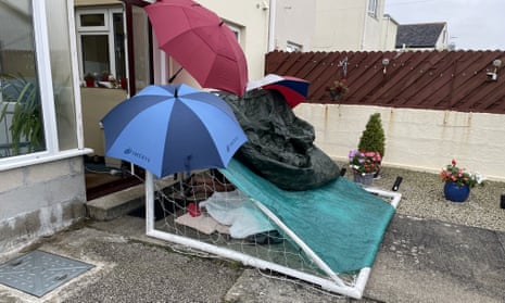 A football goal, umbrellas and a tarpaulin used to shelter David Wakeley overnight