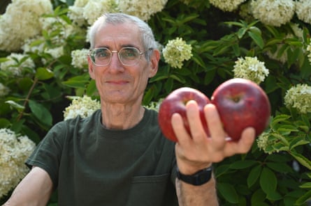 A man holding two apples