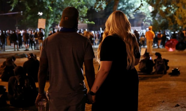 People attend a protest against racial inequality and police violence in Portland, Oregon Thursday.