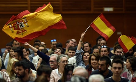 Supporters of Vox, the Spanish far-right party, wave Spanish flags.
