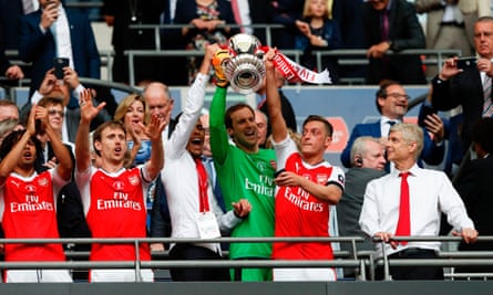 Arsenal’s Gabriel Paulista, Petr Cech and Mesut Özil lift the FA Cup as Arsène Wenger looks on after the 2-1 win over Chelsea in 2017.