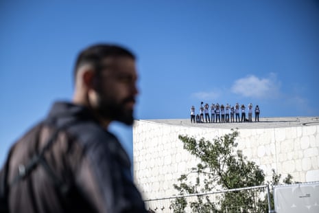 Protesters stand on top of the National Library of Israel, Jerusalem, to stage a demonstration demanding a ceasefire in Gaza, the release of Israeli hostages and the resignation of Israeli prime minister Benjamin Netanyahu and his government.