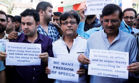 Kashmiri journalists hold placards during a protest in Srinagar on Tuesday. India banned publication of newspapers in the disputed territory for three days and raided newspaper offices.