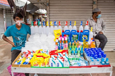 A masked man sells disinfectant and personal protective equipment on the street