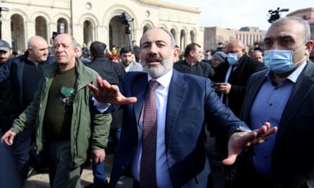 Nikol Pashinyan with arms outstretched surrounded by supporters