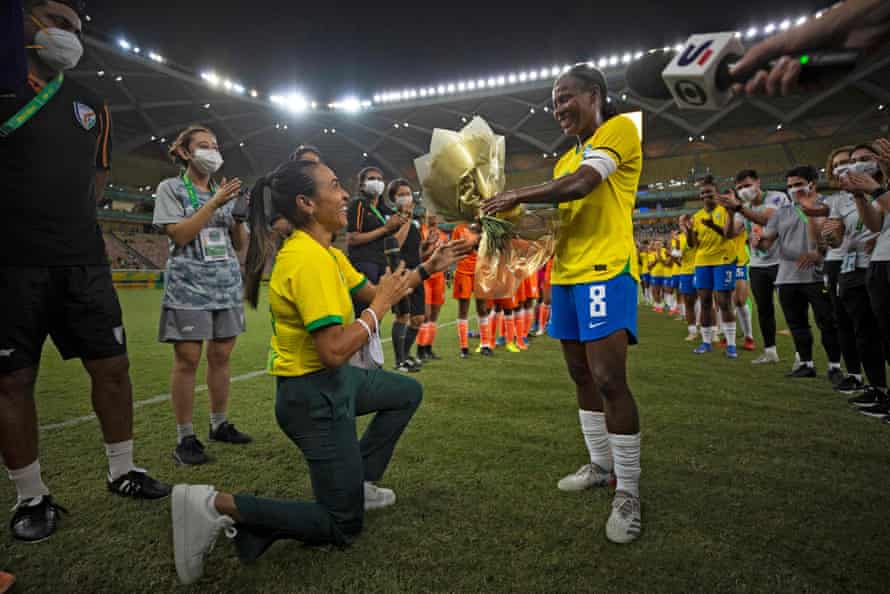 Formiga (right) receives flowers from her teammate Marta during her farewell match against India in Manaus in November 2021