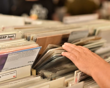 A hand going through record sleeves