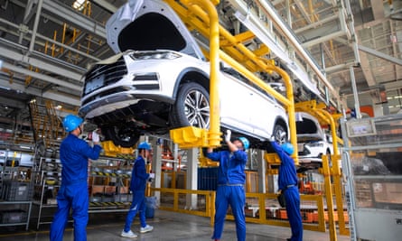 Employees work on a car at the BYD factory in Xian, China
