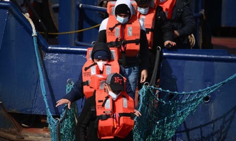 Asylum-seekers walking off boat.