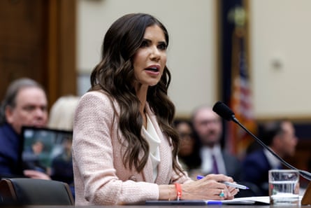 Woman sits at desk at committee hearing