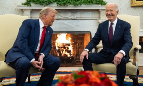 two men in suits sitting next to a fire
