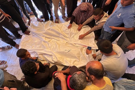 Bodies of Palestinians, who lost their lives in Israeli attacks, are received by their relatives at the Nasser hospital in Khan Younis, on Friday.