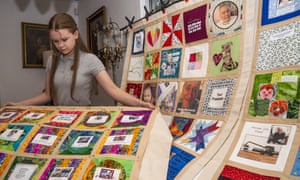 High school freshman Madeleine Fugate poses with several of her quilts, part of the COVID Memorial Quilt living memorial to honor and remember all those lost to COVID-19, at her home in Los Angeles
