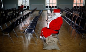 A man dressed in a Santa Claus costume attends an annual