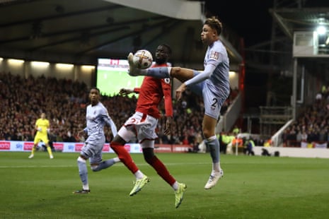 Cheikhou Kouyate of Nottingham Forest looks on as Aston Villa’s Matty Cash controls the ball in an acrobatic style.