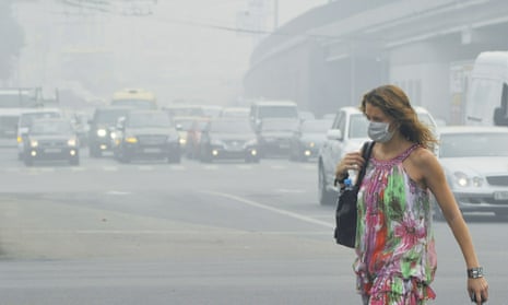 A Russian woman wears a face mask to protect herself from acrid smoke while walking in central Moscow on August 9, 2010. Air pollution from a heatwave-fueled forest fire smog caused hundreds of extra deaths each day compared to a normal period.