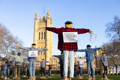 A view of 49 scarecrows outside the Houses of Parliament in London, as part of Riverford's 'Get Fair About Farming' campaign, calling for the Government to force the leading supermarkets to adopt fairer principles for British farmers. Picture date: Monday January 22, 2024. PA Photo. Research reveals that nearly half of fruit and veg farmers fear closure within 12 months, with supermarket buying behaviour a leading cause. Photo credit should read: David Parry/PA Wire