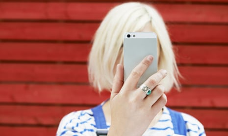Woman holding up mobile for selfie