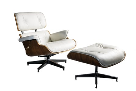 An Eames lounge chair and ottoman in white leather upholstery