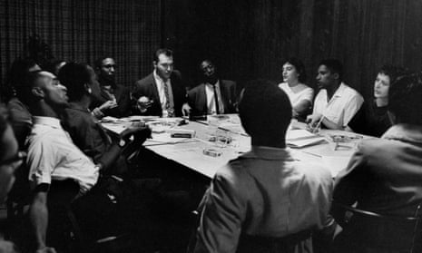 Members of SNCC sitting around a table planning