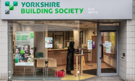 A woman sanitisers her hands inside a branch of Yorkshire building society