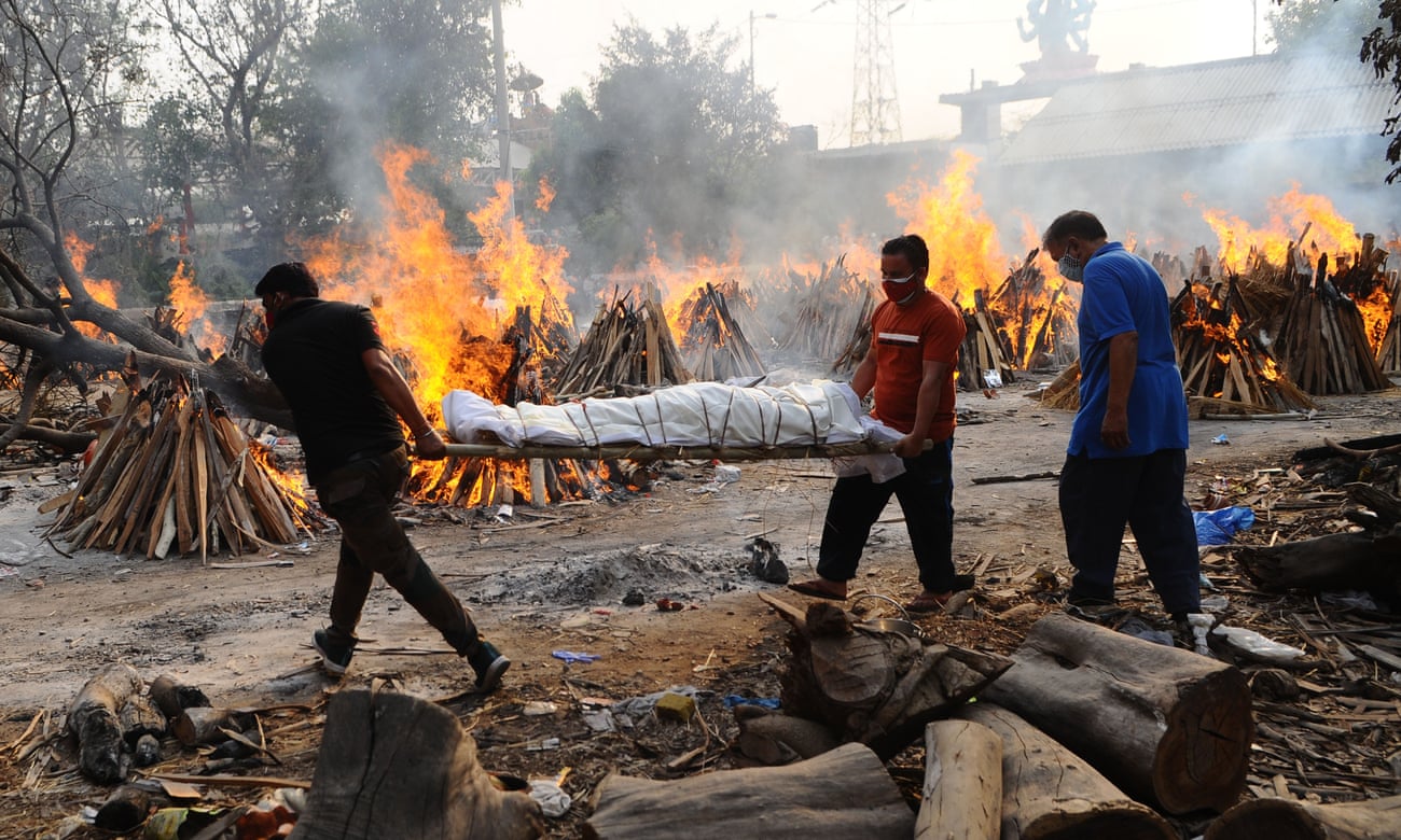 The body of a person who died from coronavirus is carried at mass cremation in New Delhi