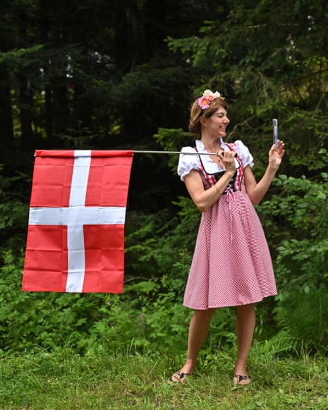 Tour de France 2023: Rodríguez wins stage 14 as Vingegaard keeps yellow jersey – live | Tour de France 2023 7 A spectator wearing traditional attire holds a Danish national flag along the race route.